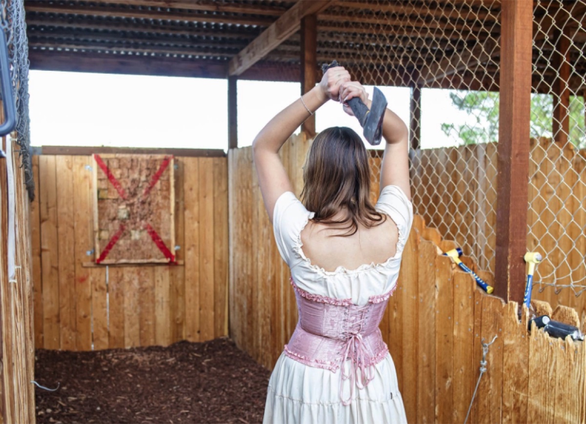 Axe Throwing Cowgirl at Blazin' M Ranch Frontier Town